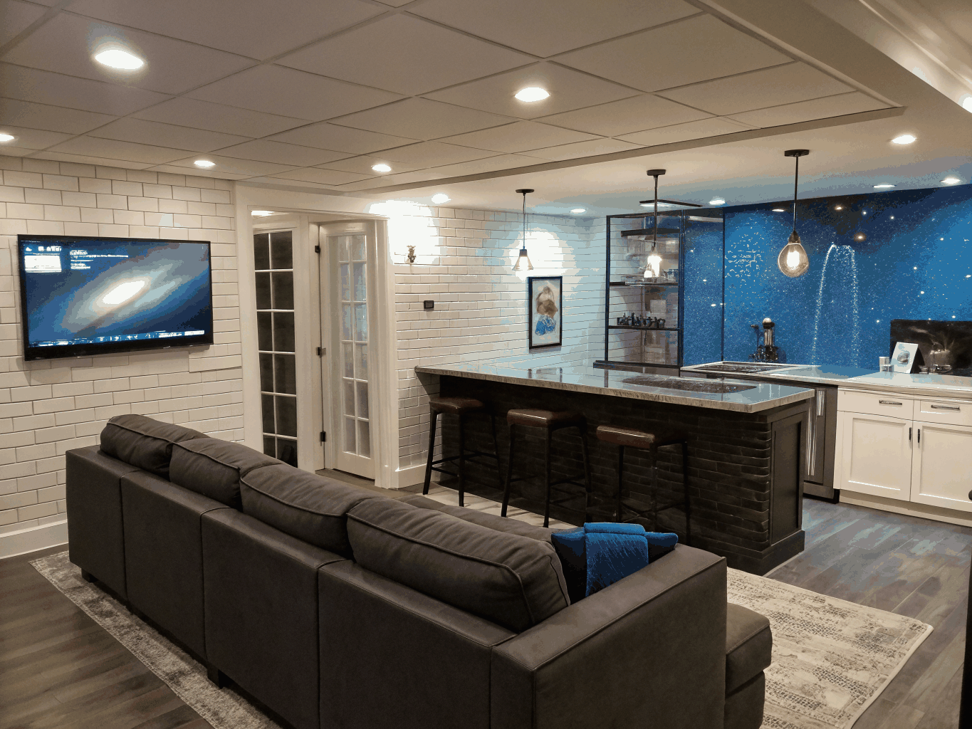 Finished terrace-level basement in North Georgia with custom white oak bar and recessed lighting